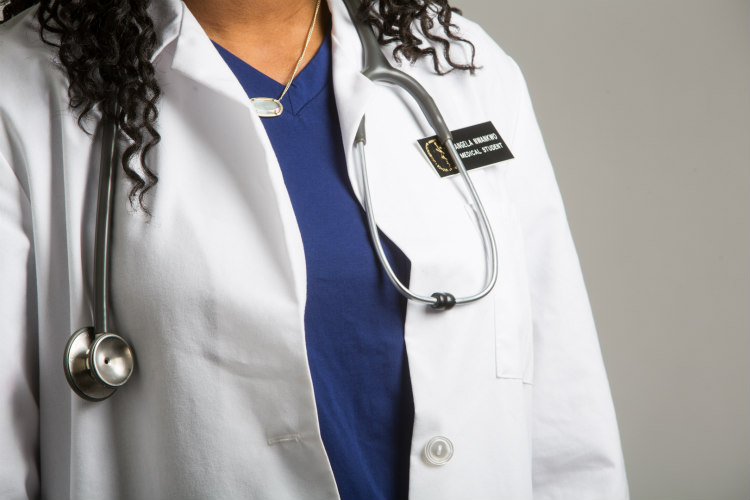 Closeup of medical student Angela Nwankwo's white coat, showing a stethoscope